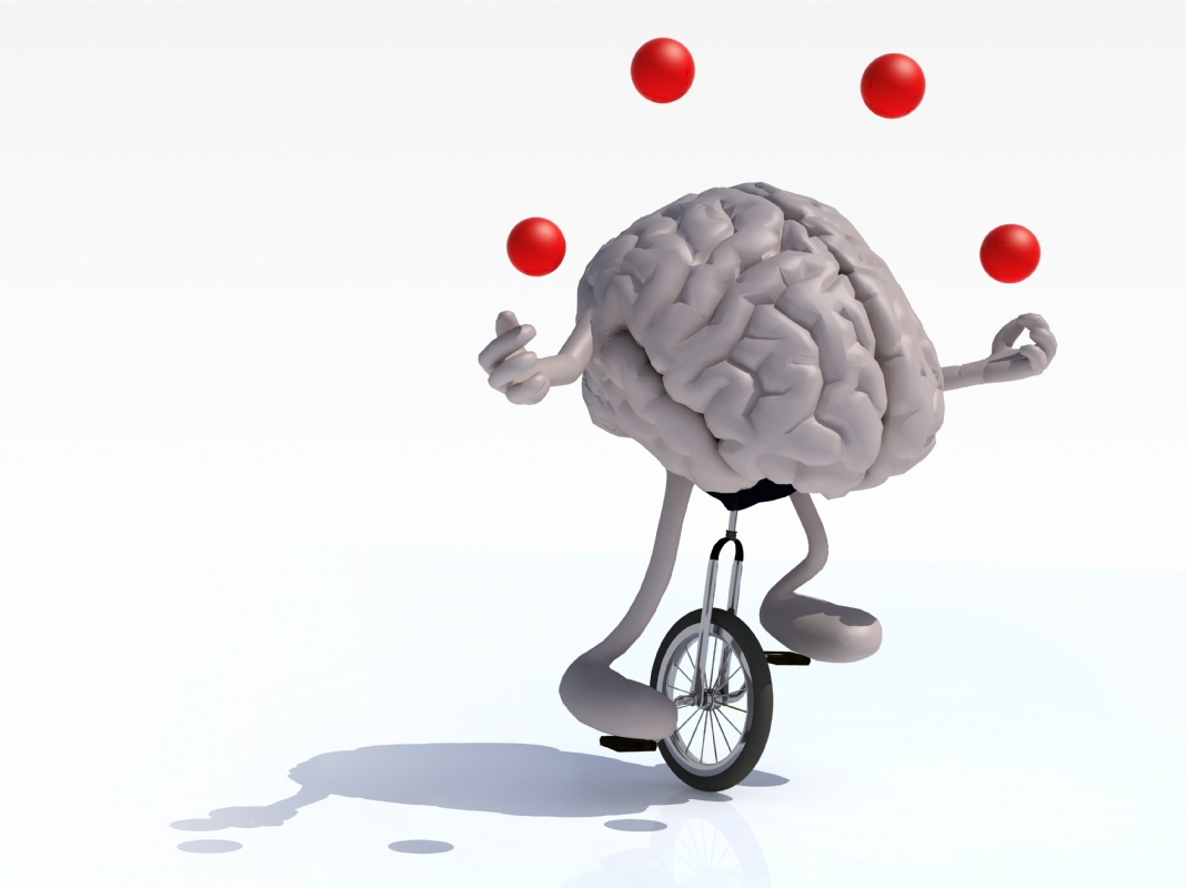 The image shows a human brain riding a unicycle while juggling red balls in the air. The brain is depicted with arms and legs, actively balancing and multitasking. This visual metaphor highlights the concept of brain function as the ability to manage multiple tasks simultaneously