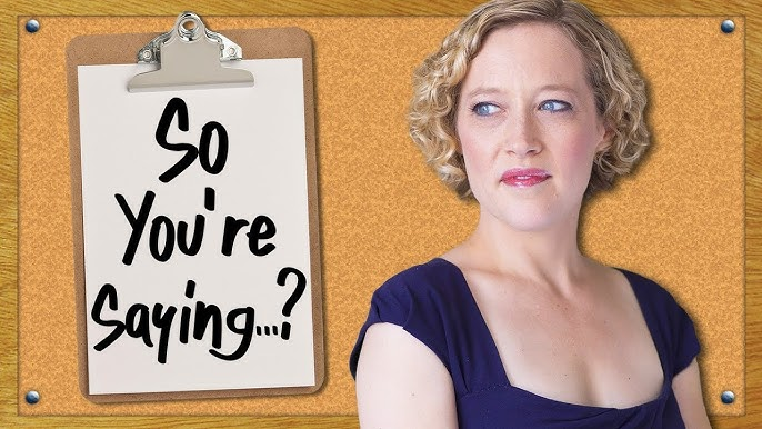 Clipboard with "So you're saying...?" text on a corkboard next to a person in a blue top.