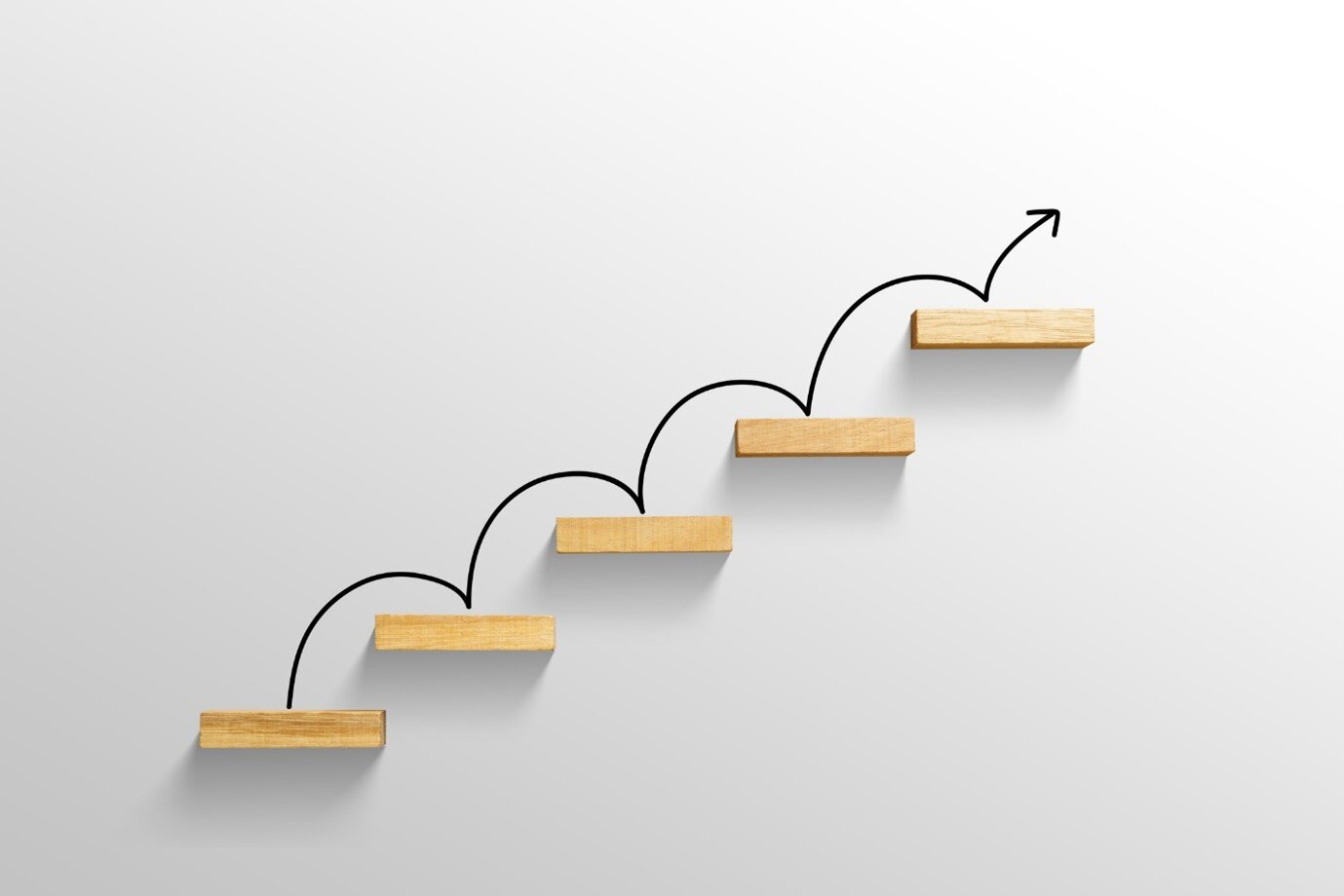 Stylized wooden steps forming upward arrow on a white background.